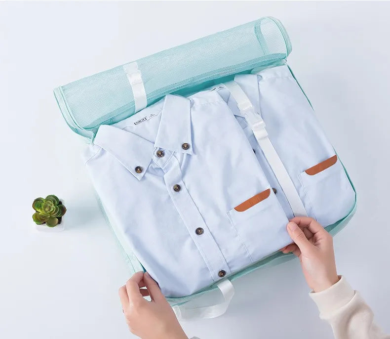 Clothes being packed into a travel packing cube